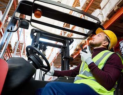 This warehouse worker is operating a forklift.